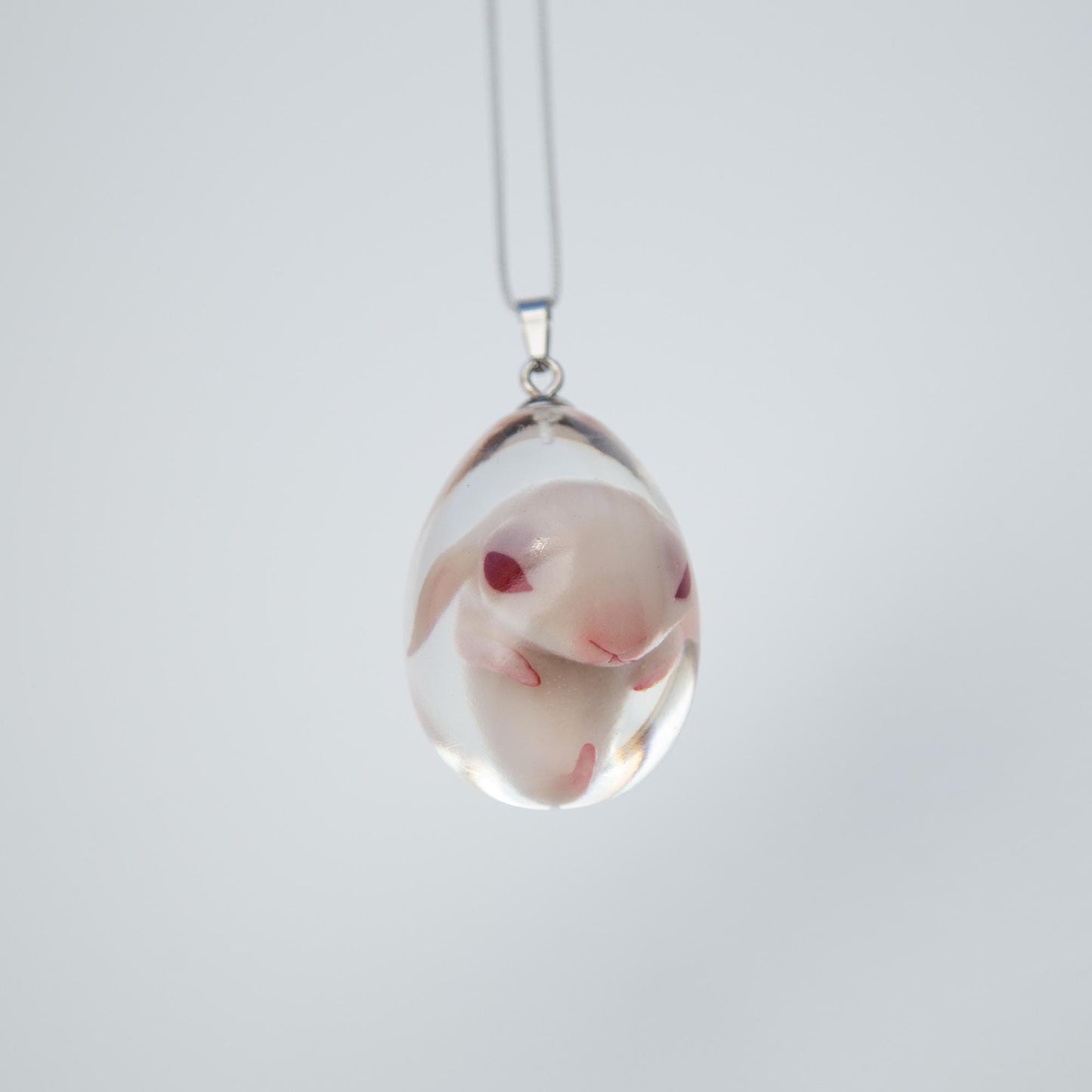 Baby Rabbit in egg pendant. Embryo horror jewelry, necklace with cute rabbit inside