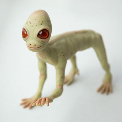 The Dover Demon from Massachusetts. A creature from an urban legend, a small, very thin humanoid of green color, a melon-like head with amber large eyes. The sculpture is made of polymer, the eyes are made of epoxy