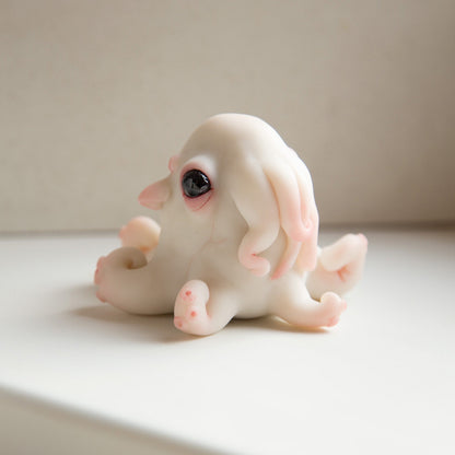 Cute albino baby fantasy octopus. It has tentacles, white skin and red eyes. Also you can see veins and sukers on tentacles
