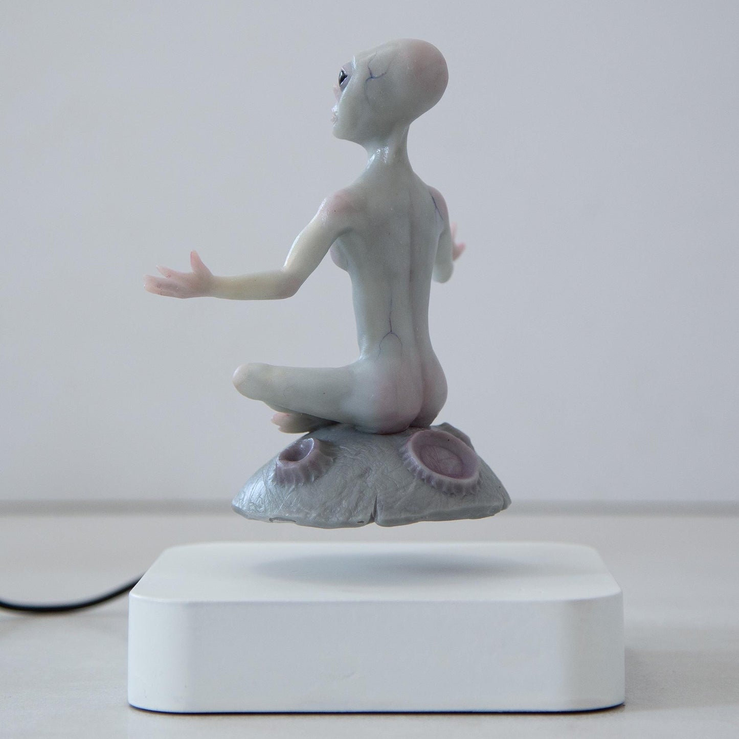 Magnetic levitation kinetic sculpture of alien, art doll creature from fantastic planet