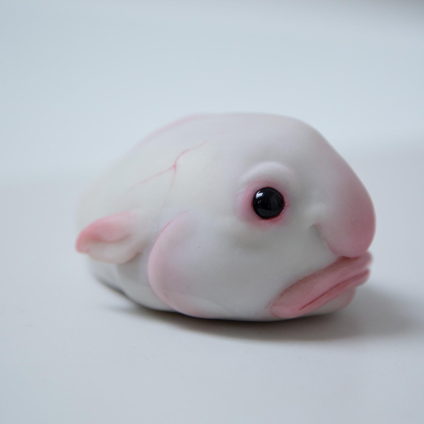 Cute sad and funny blobfish anime figurine, weird geek pop art sculpture