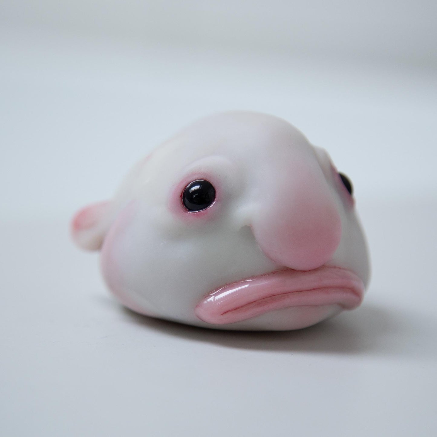 Cute sad and funny blobfish anime figurine, weird geek pop art sculpture