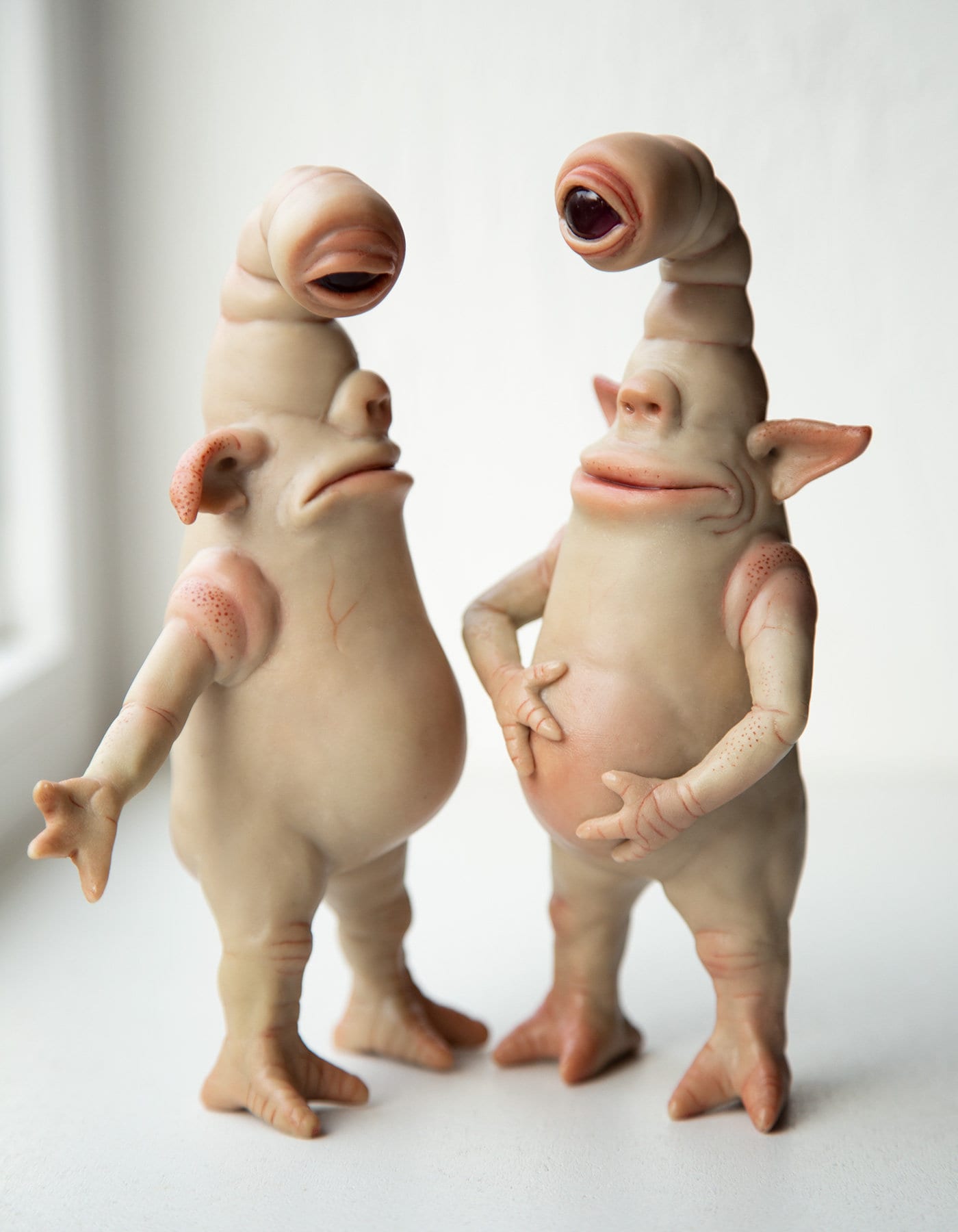 Pair of cyclops-goblins funny brothers, sad and happy, cute goblin figures