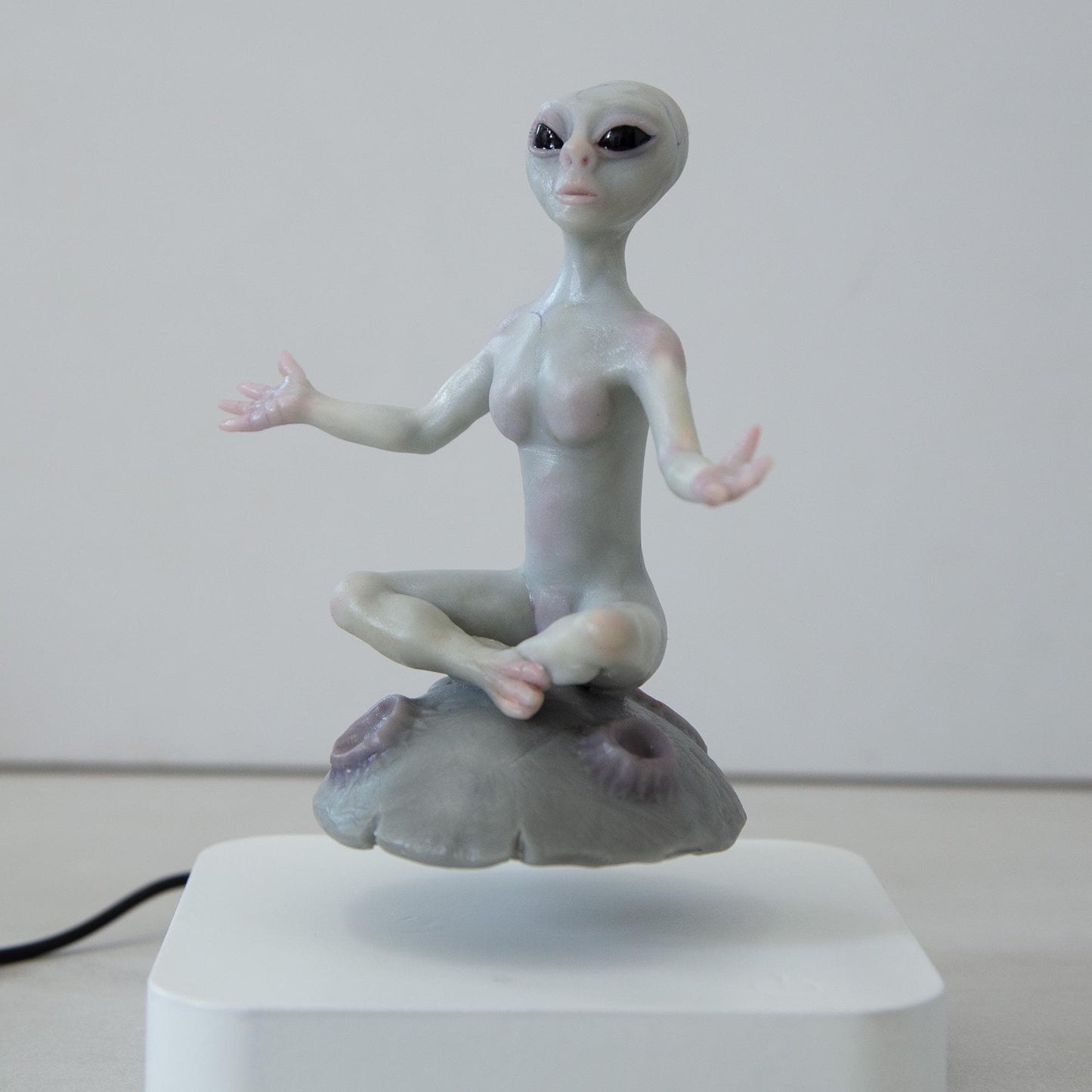 Magnetic levitation kinetic sculpture of alien, art doll creature from fantastic planet