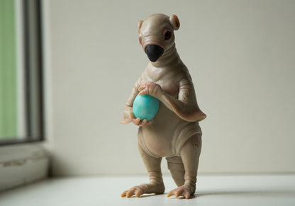 Strange, weird and unusual creepy alien doll sculpture, fantastic pinguin like beast, creepy surreal dark art