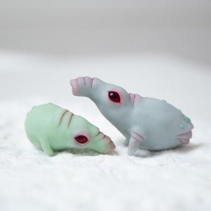 Pair of very cute and funny baby piggies with glow in the dark pips. They are in light mint and light gray colors, stays in different positions