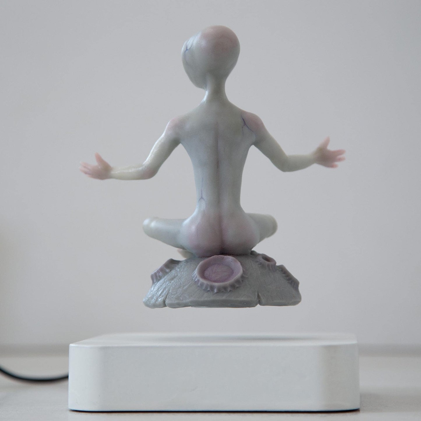 Magnetic levitation kinetic sculpture of alien, art doll creature from fantastic planet