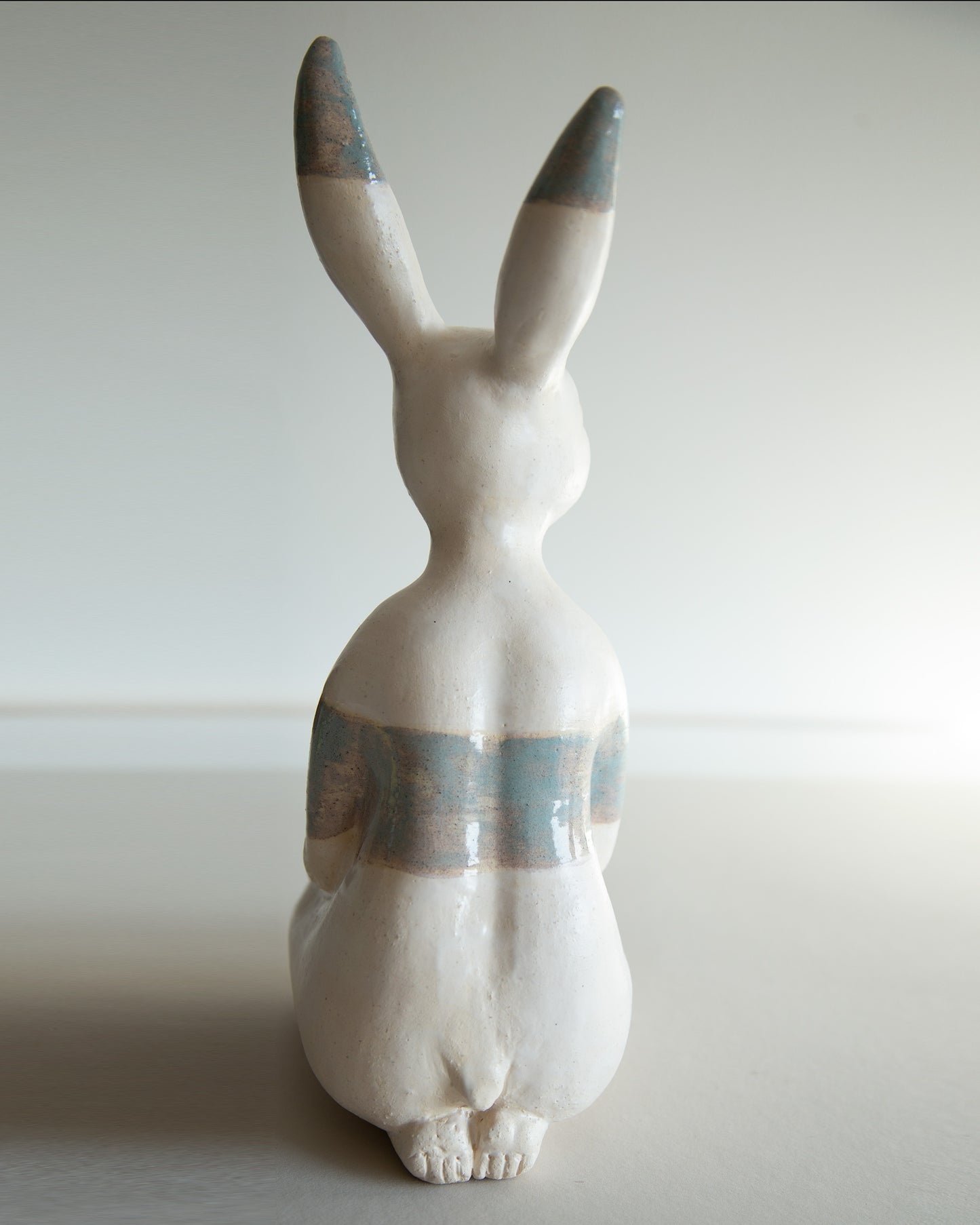 Ceramic statue of hare bodypositive girl, whimsical guitar body rabbit character, weird bunny sculpture decor