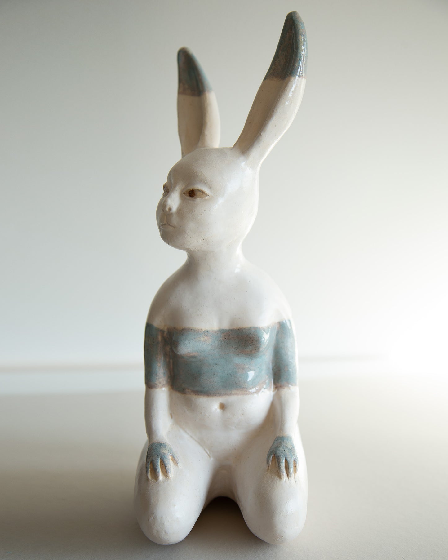 Ceramic statue of hare bodypositive girl, whimsical guitar body rabbit character, weird bunny sculpture decor