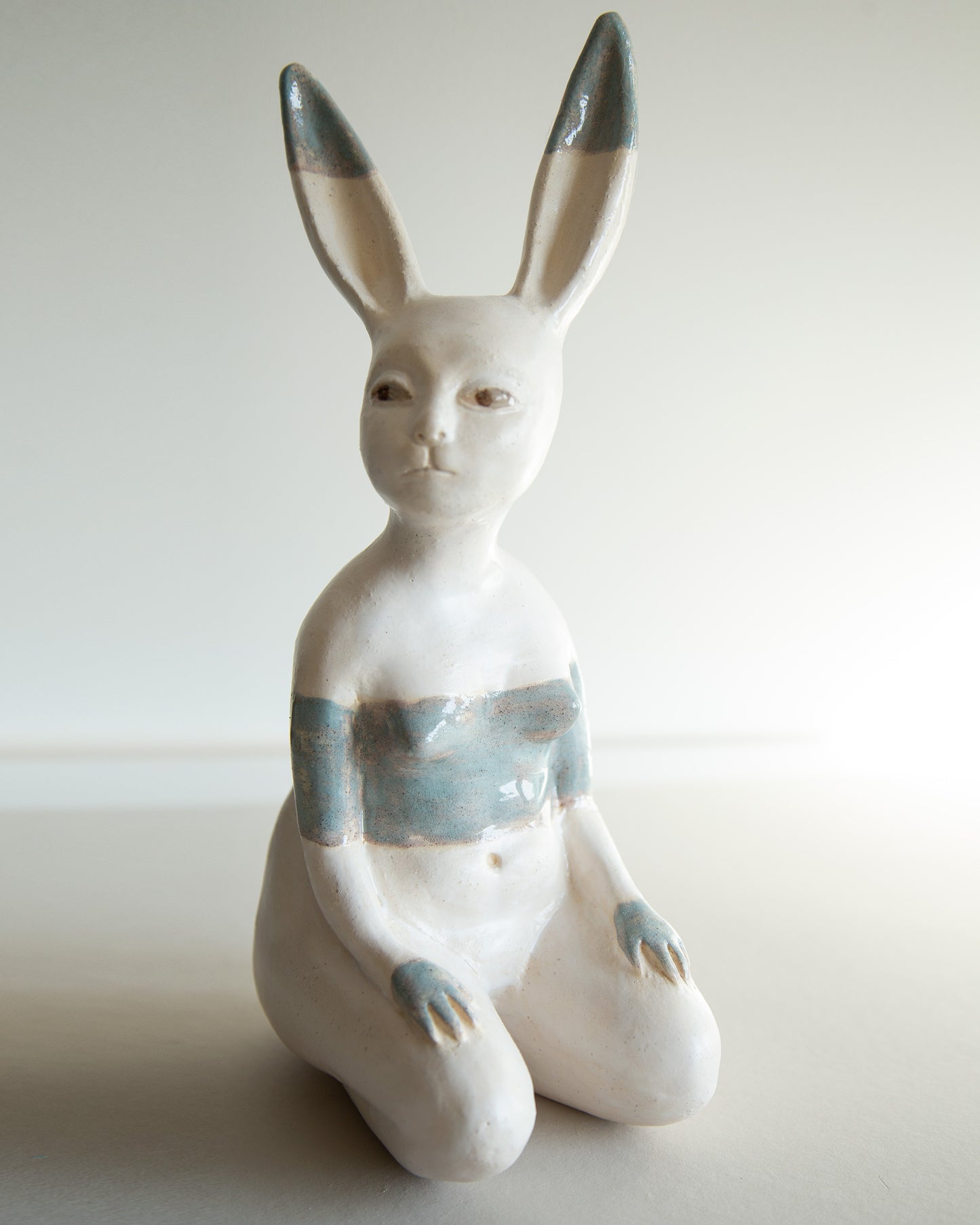 Ceramic statue of hare bodypositive girl, whimsical guitar body rabbit character, weird bunny sculpture decor