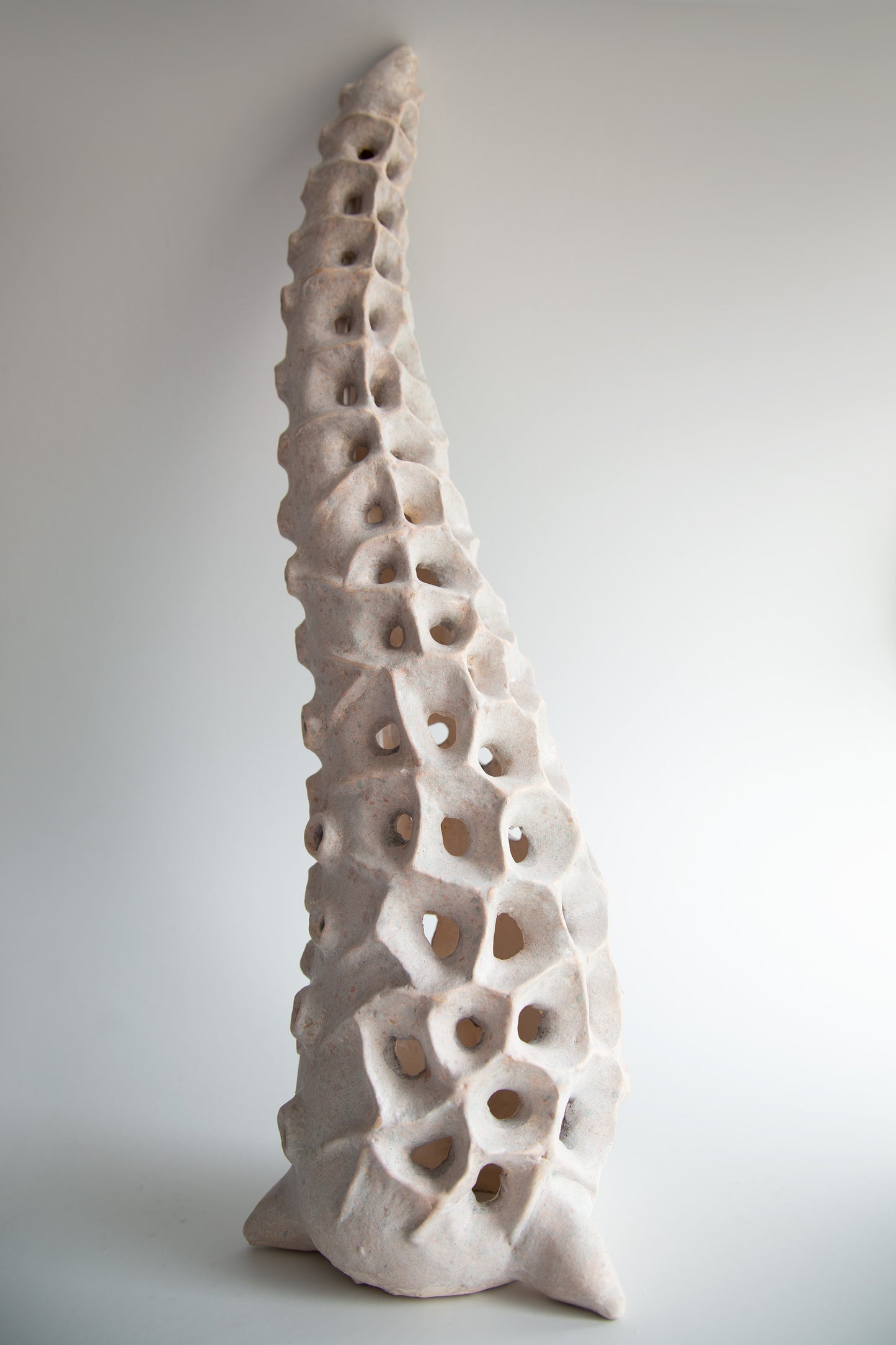 Close-up of the textured ceramic surface with organic perforated pattern