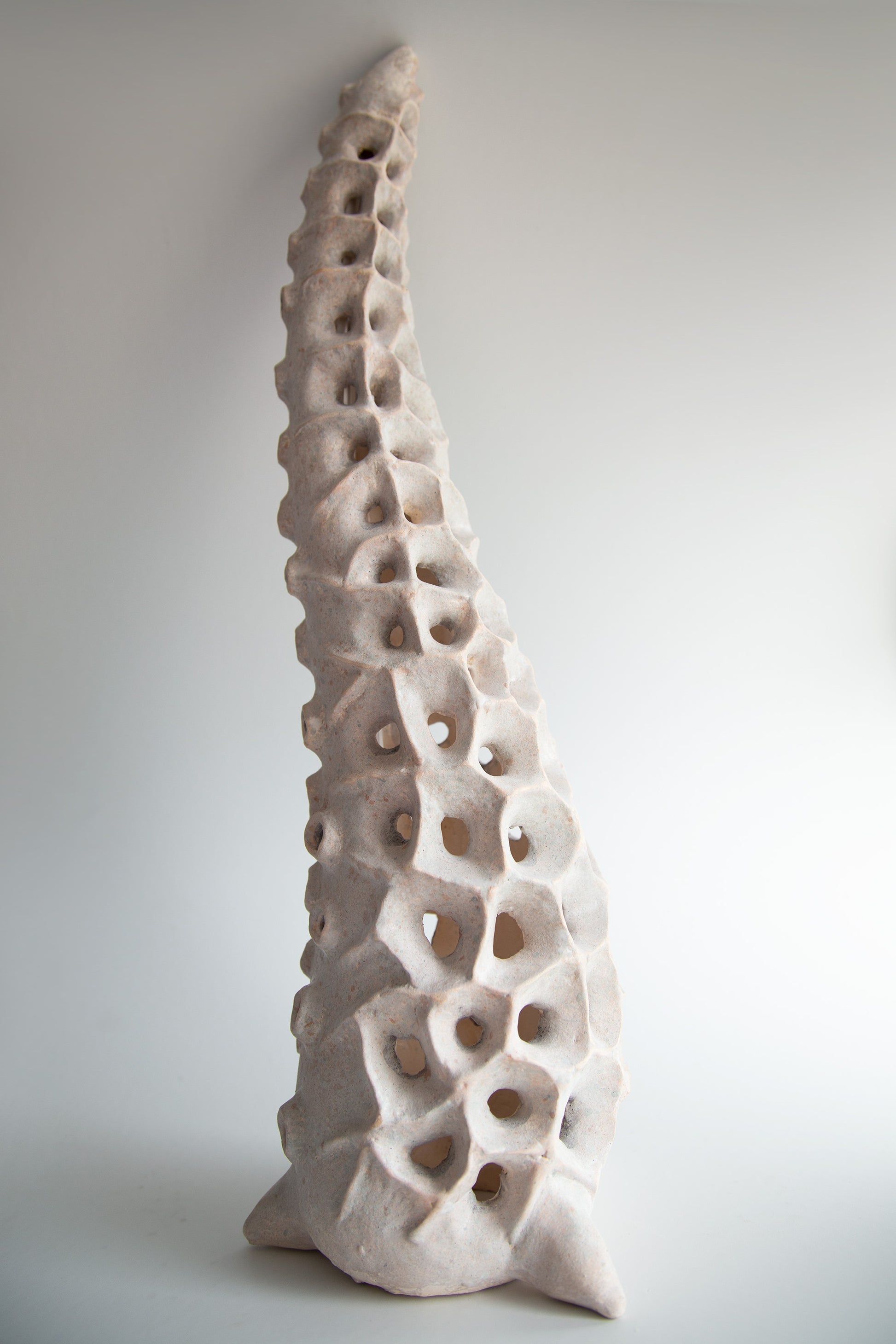 Close-up of the textured ceramic surface with organic perforated pattern