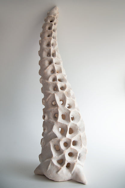 Close-up of the textured ceramic surface with organic perforated pattern