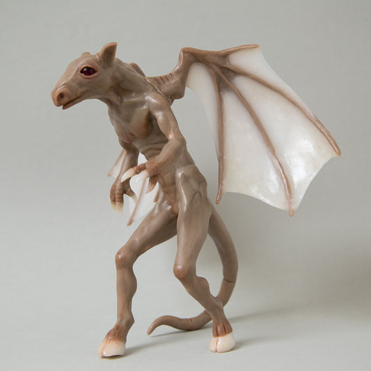 Handmade sculpture of brown skin hybrid fanasy animal, known as Jersey Devil. Horse like demon creature with dragon wings made from translucent polymer