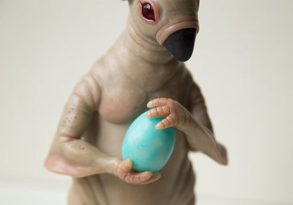 Strange, weird and unusual creepy alien doll sculpture, fantastic pinguin like beast, creepy surreal dark art