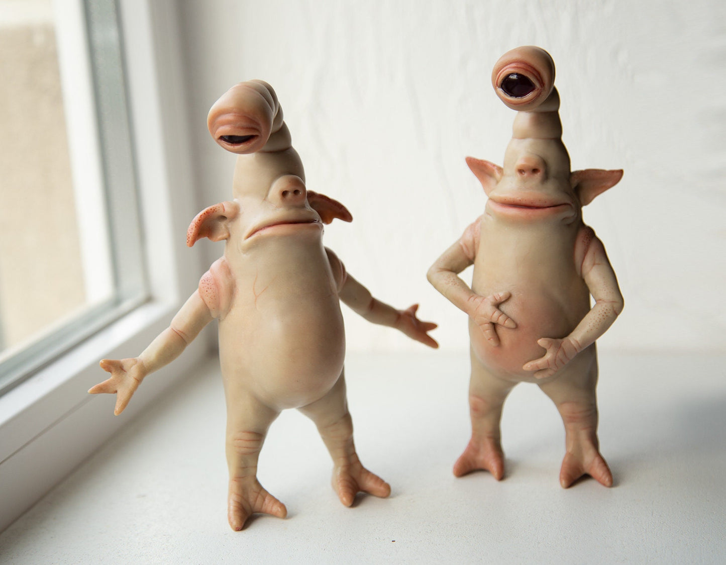 Pair of cyclops-goblins funny brothers, sad and happy, cute goblin figures