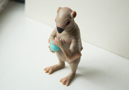 Strange, weird and unusual creepy alien doll sculpture, fantastic pinguin like beast, creepy surreal dark art