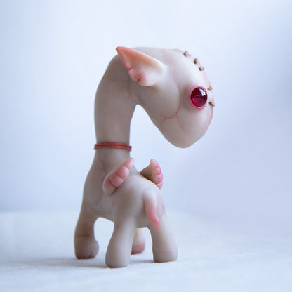 A pegasus horse figurine in a mixed anime-steampunk style. It has small wings, a scar on its face and a stitched-up eye, but it is beige and very cute, with cartoonish body proportions.