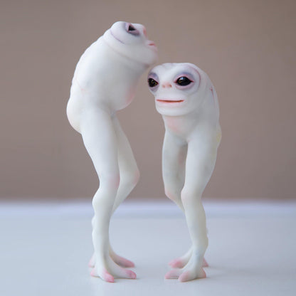 Pair of Fresno Nightcrawlers, famous California cryptid creatures. This alien lifeform doesn't have hands, only small white body with long legs. Here is a sculpture of two of them, made from white polymer and black epoxy eyes 