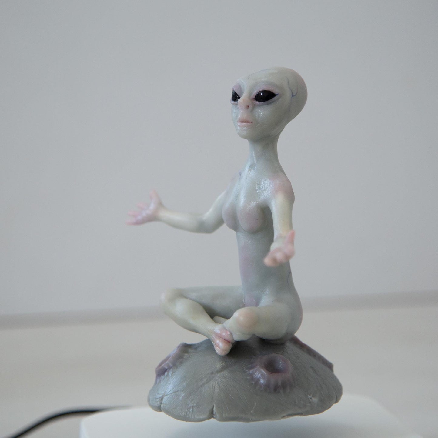 Magnetic levitation kinetic sculpture of alien, art doll creature from fantastic planet