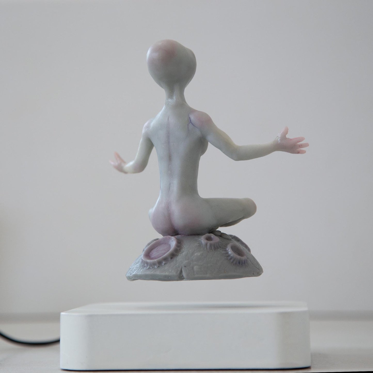 Magnetic levitation kinetic sculpture of alien, art doll creature from fantastic planet