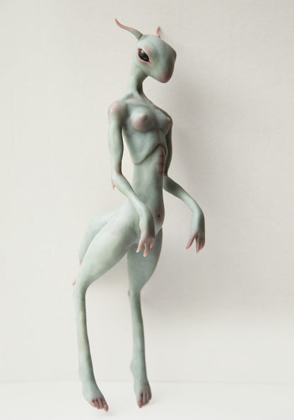 Handmade sculpture of thin and sexy gray alien girl, hybrid humanoid - cricket lifeform. It has gray semi translucent scin, red veins, fingers on hands, and even small tits, awesome sexy alien statue