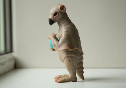 Strange, weird and unusual creepy alien doll sculpture, fantastic pinguin like beast, creepy surreal dark art