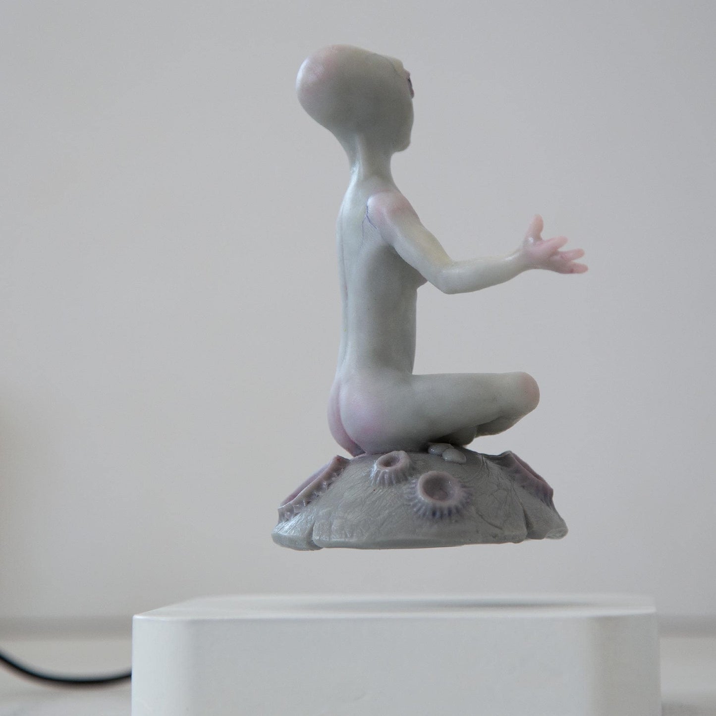 Magnetic levitation kinetic sculpture of alien, art doll creature from fantastic planet