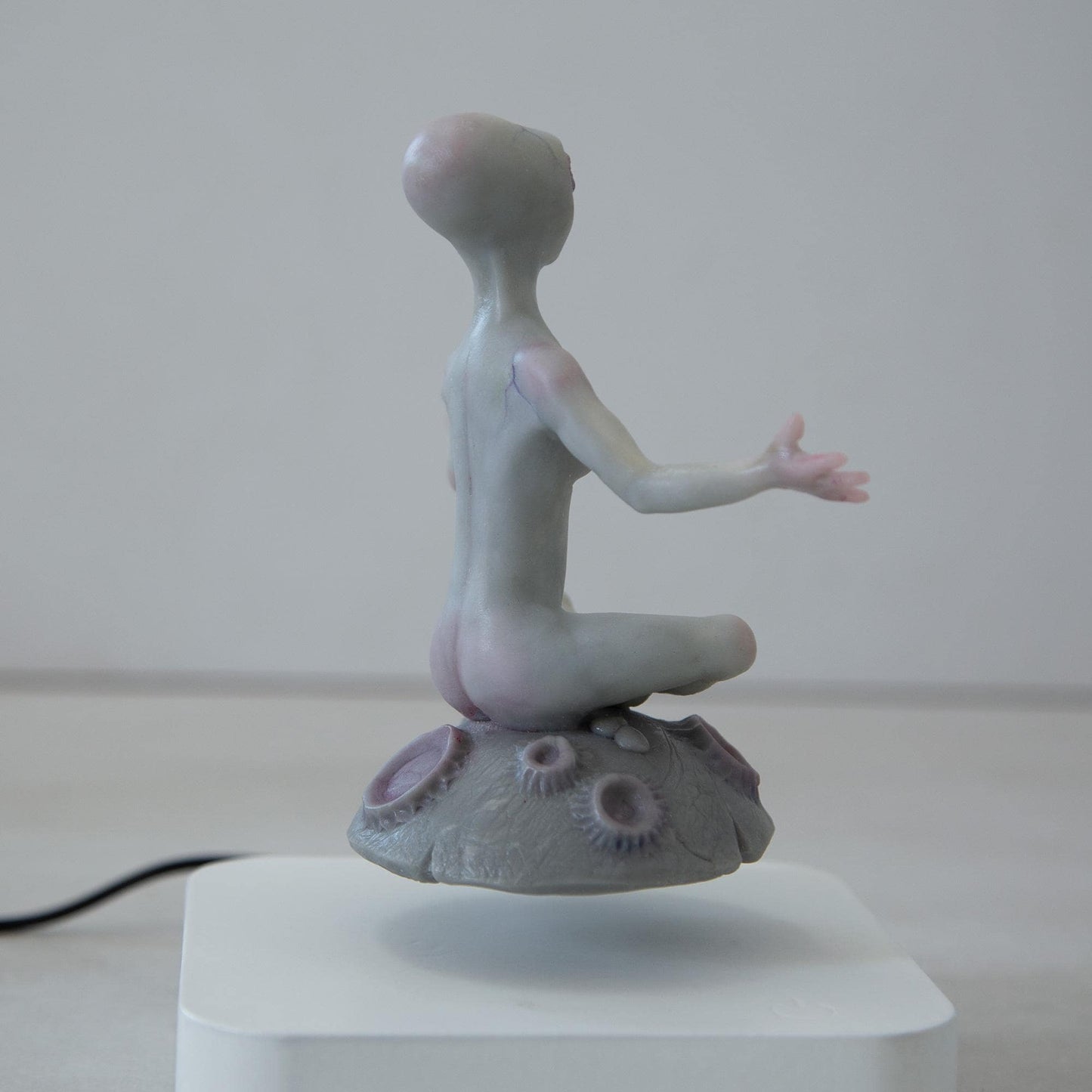 Magnetic levitation kinetic sculpture of alien, art doll creature from fantastic planet