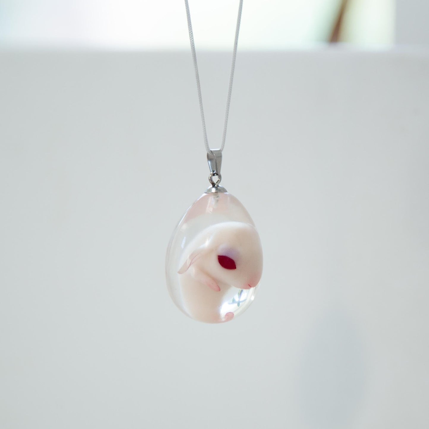 Baby Rabbit in egg pendant. Embryo horror jewelry, necklace with cute rabbit inside