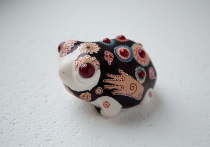 An anime style African rain frog figurine, painted with traditional African folk ornament. Traditional African colors and motifs of the ornament were used. The figurine is made of acrylic compound, then hand painted