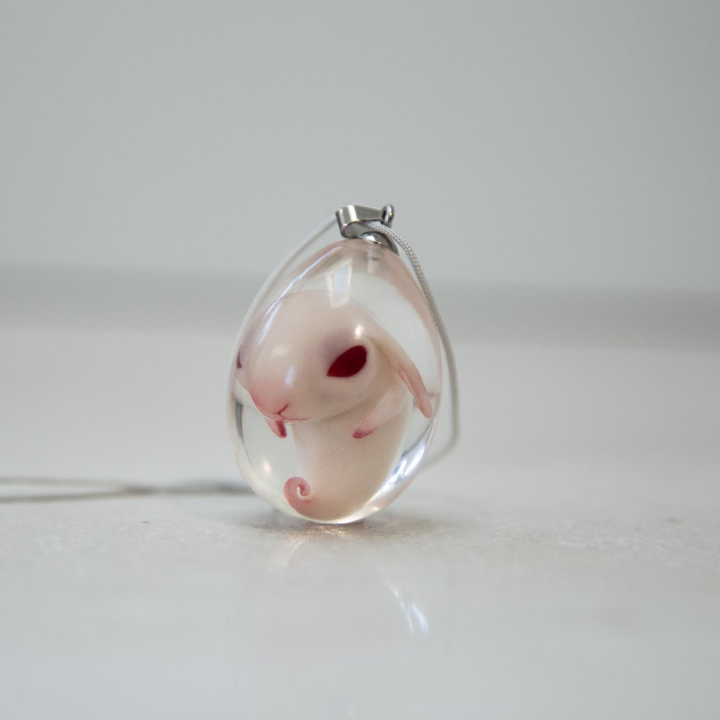 Baby Rabbit in egg pendant. Embryo horror jewelry, necklace with cute rabbit inside