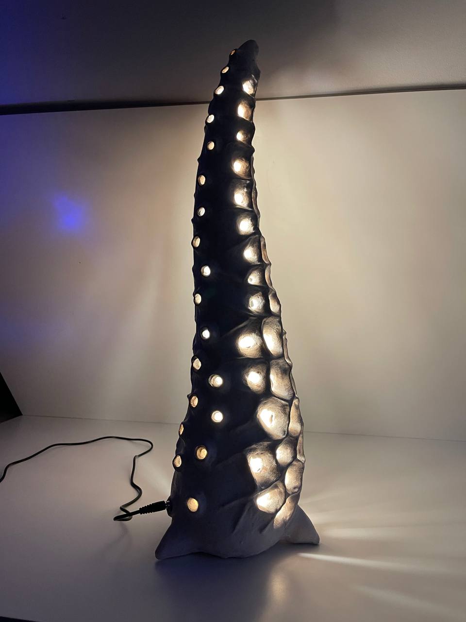 Handmade ceramic floor lamp glowing with warm ambient LED light